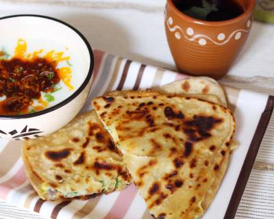 Breakfast Meal Plate: Stuffed Egg Paratha, Tadka Raita And Basil Tea