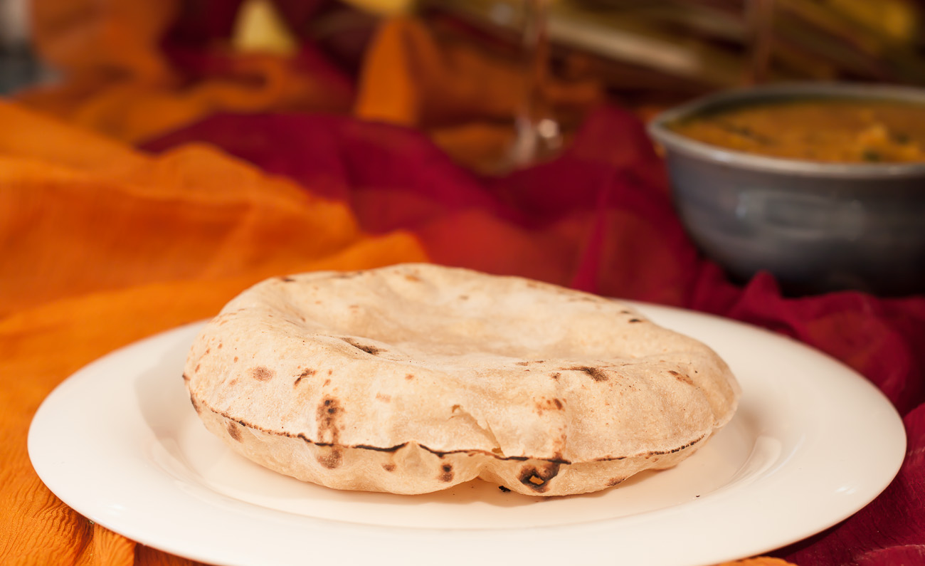 Image of Making Roti (Indian Chapati) On Roti Tawa Made Of Wheat