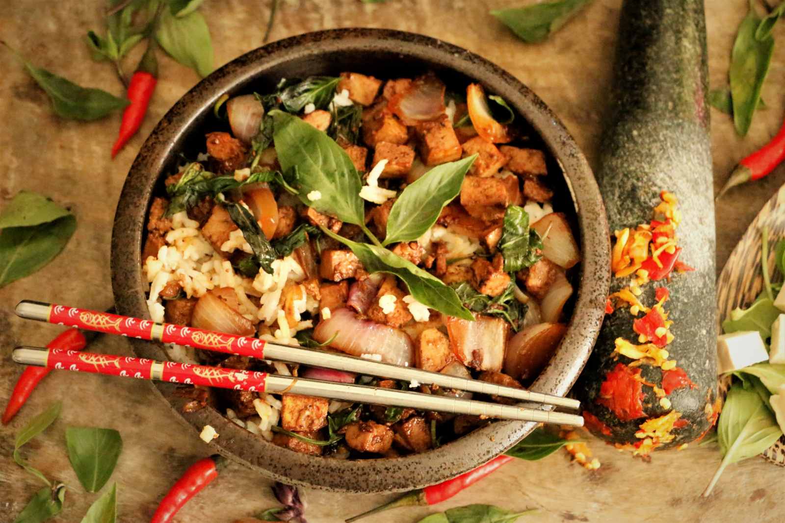 layered thai basil and tofu in bowl with chop sticks