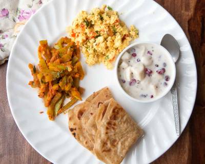 Everyday Meal Plate : Paneer Bhruji, Chichinda Ki Sabzi,Kela Anar Raita & Tawa Paratha