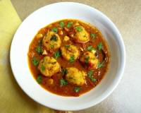 Chettinad Paruppu Urundai Kuzhambu (Steamed Lentil Balls Cooked in a Tangy Curry) Recipe