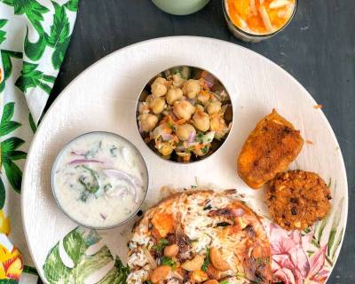 Try This Delectable Dinner Menu- Paneer Butter Masala Biryani, Onion Raita, Kalmi Vada, Chickpea Salad, Pudina Lassi & Mango Kheer